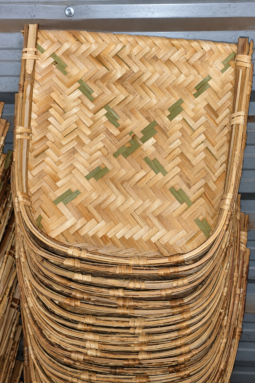 Stacks of woven trays in the workshop